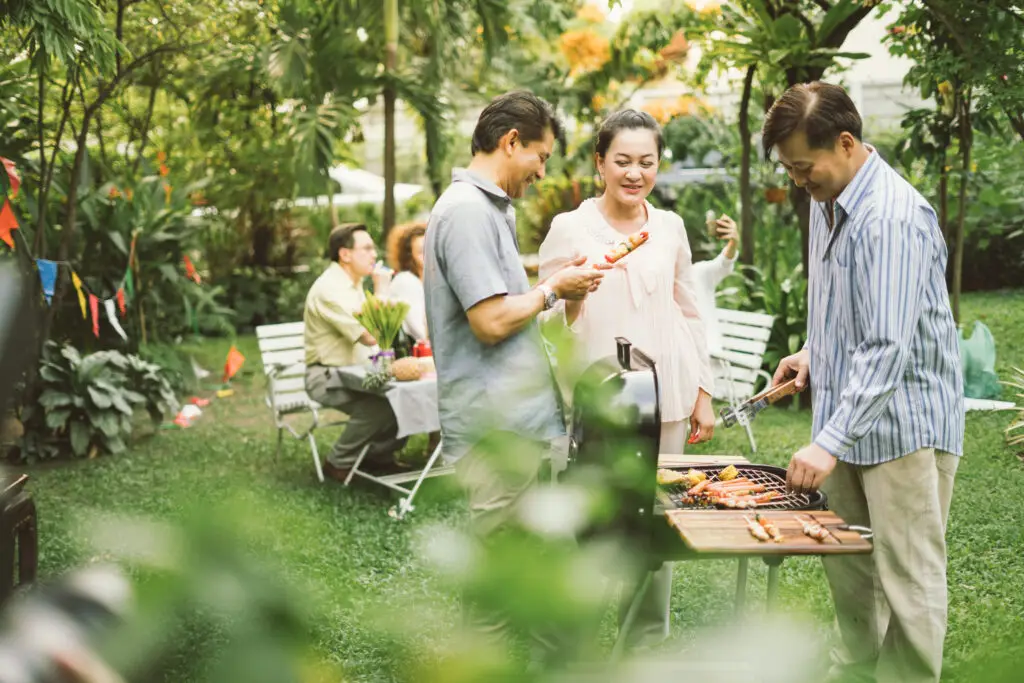 Family,And,Friends,Gathered,Together,At,The,Table.cooking,Bbq,Outdoor
